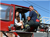 Firefighter Shows Girl Inside of Fire Truck