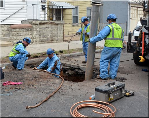 Public Works Employees Doing Plumbing Work