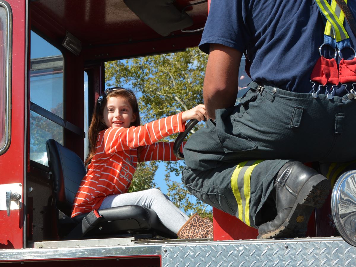 Little Girl Sits in Fire Truck