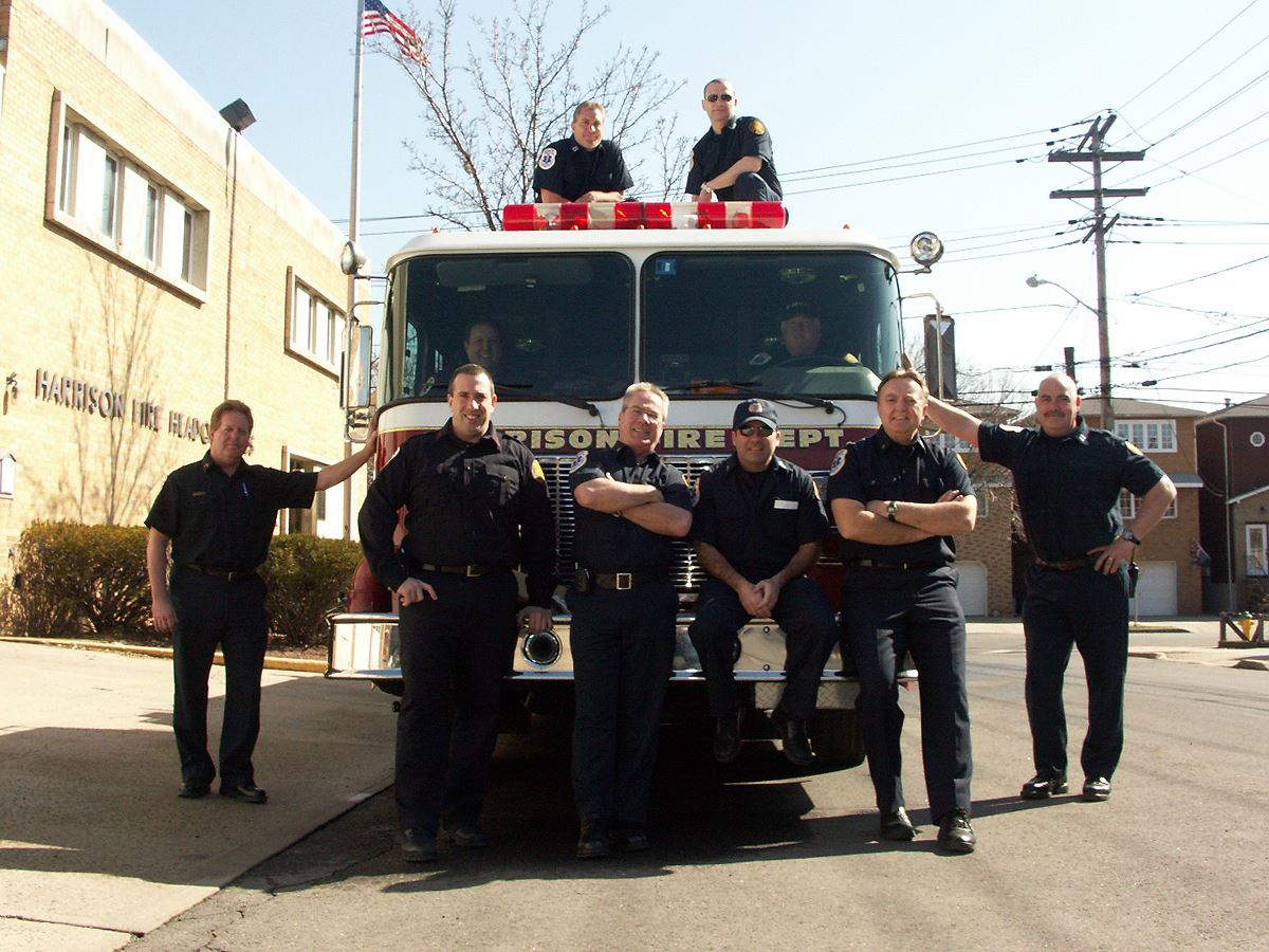 Members of Fire Department Standing in Front of Fire Truck
